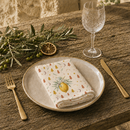 Lemon and pine Christmas napkin on a set table, the lemons and little Christmas trees in view