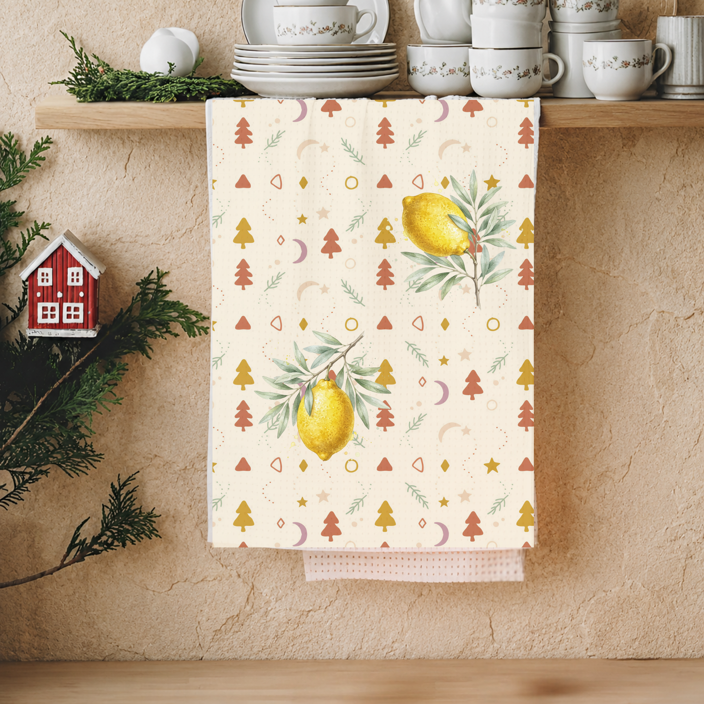 Lemon and pine Christmas kitchen towel hanging in a kitchen, the lemons and little trees in view