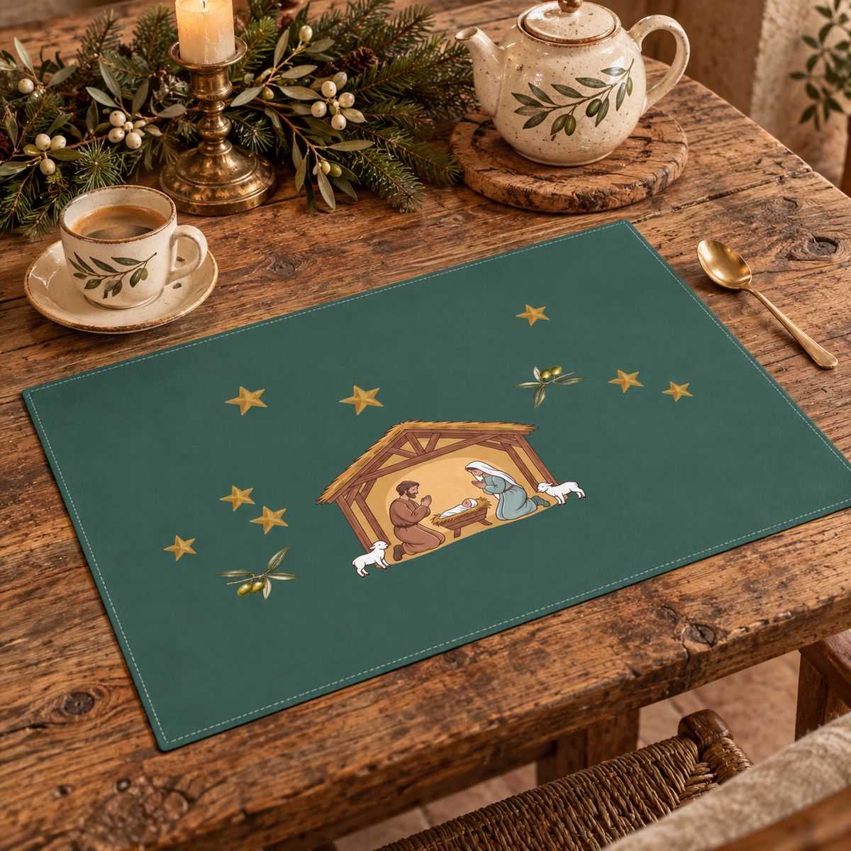 Nativity & Olive Christmas placemat at a laid place setting, the nativity stable and two lambs on deep green