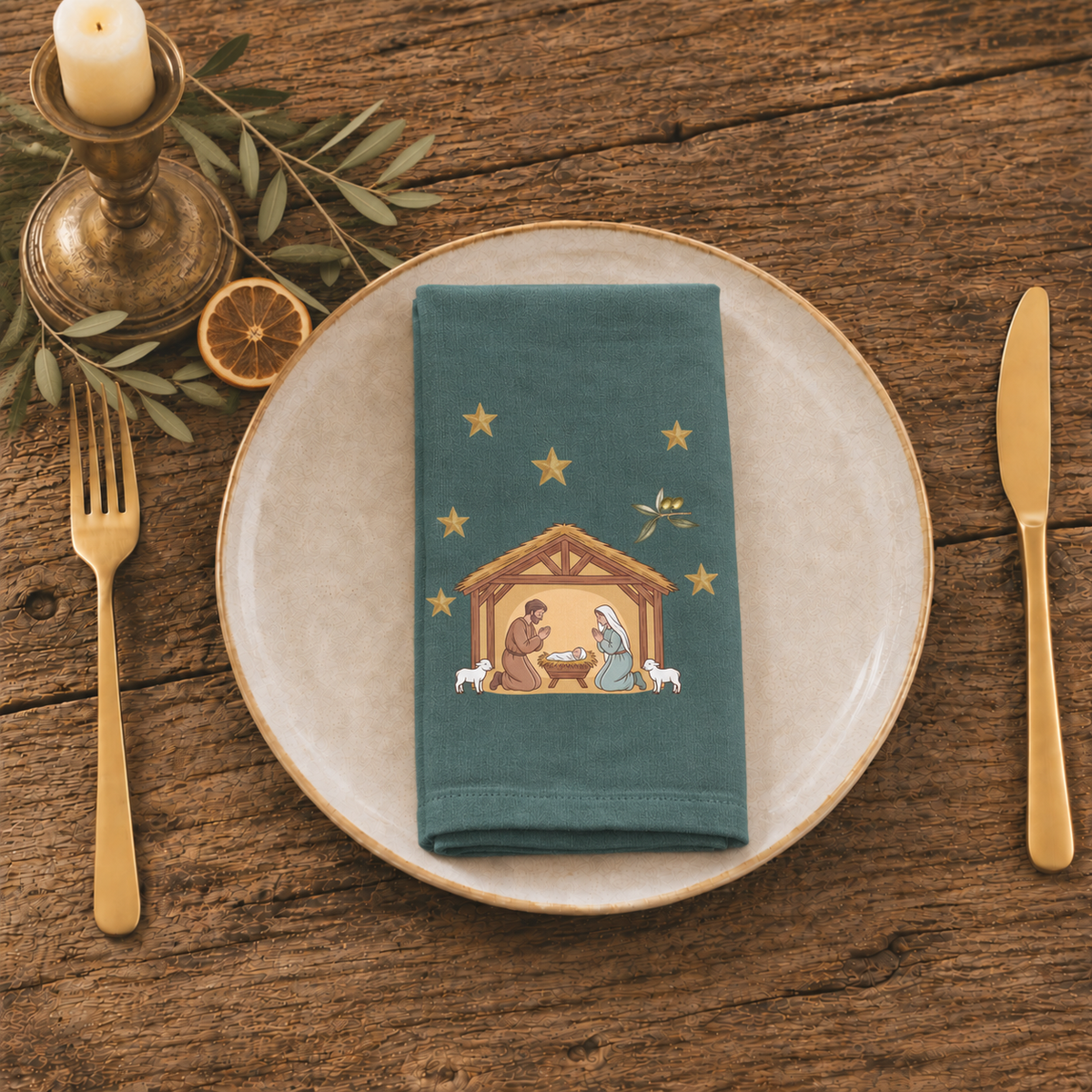 Nativity & Olive Christmas cloth napkin folded at a place setting, the nativity stable on deep green