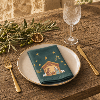 Nativity & Olive Christmas cloth napkin on a laid Christmas table, gold stars and olive sprigs on deep green