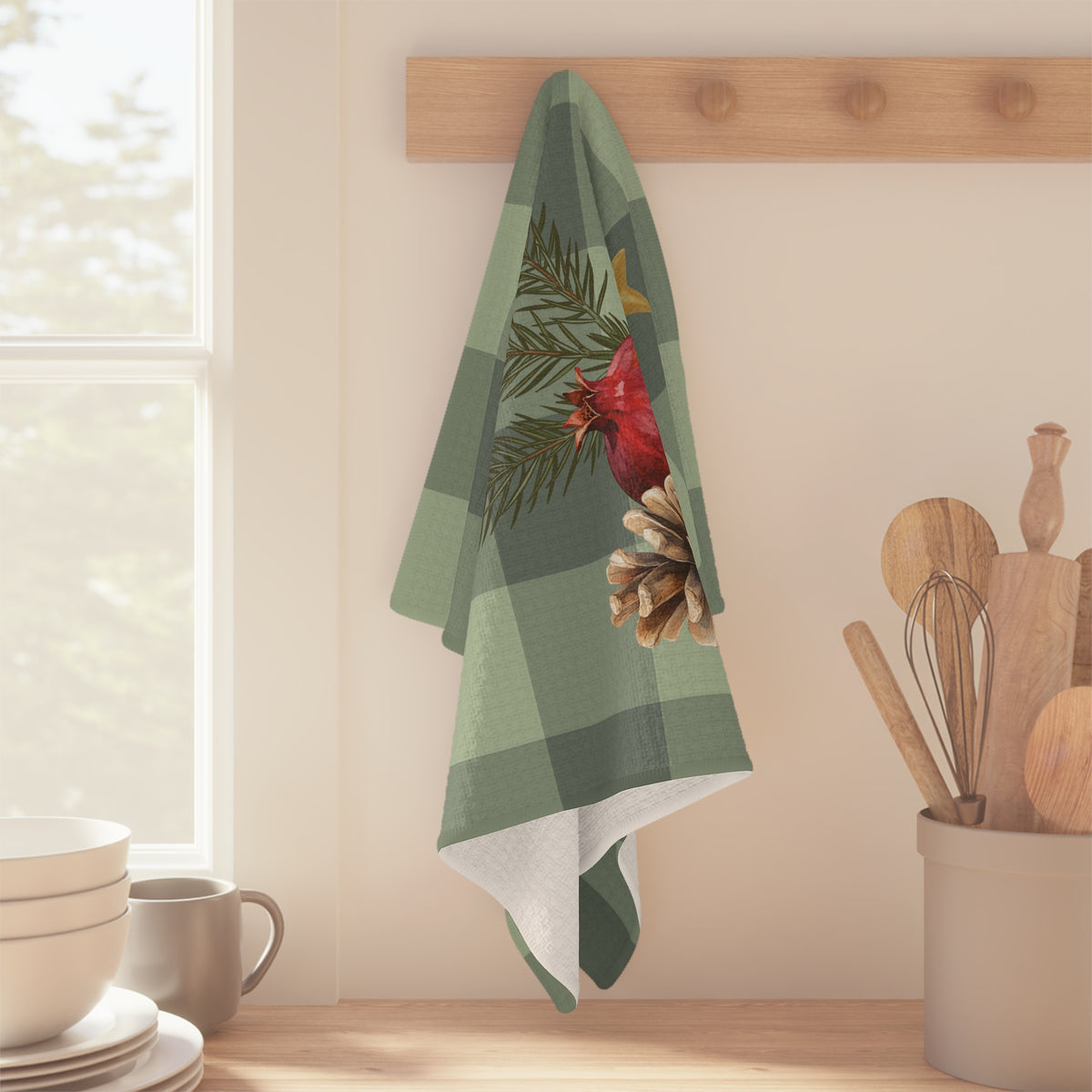 Pomegranate & Pine Gingham Christmas tea towel, a pomegranate, pine cone, orange slice and gold star under a pine spray on a sage green gingham check