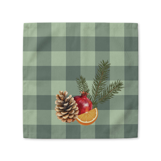 Pomegranate & Pine Gingham Christmas cloth napkin, a pomegranate, pine cone, orange slice and gold star under a pine spray on a sage green gingham check