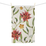 Poinsettia & Mistletoe Christmas tea towel, red poinsettias and mistletoe on cream, hanging in a kitchen