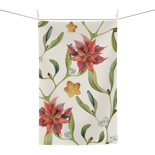Poinsettia & Mistletoe Christmas tea towel, red poinsettias and mistletoe on cream, hanging in a kitchen