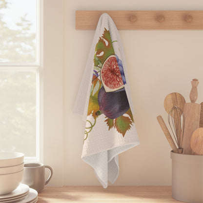 Fig & Grape fall tea towel, purple grapes and turning vine leaves, folded on a counter