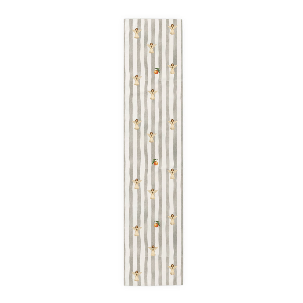 Grey and cream striped Christmas table runner with cream angels holding pine sprigs of red berries, and single oranges between them, laid flat