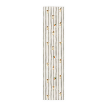 Grey and cream striped Christmas table runner with cream angels holding pine sprigs of red berries, and single oranges between them, laid flat