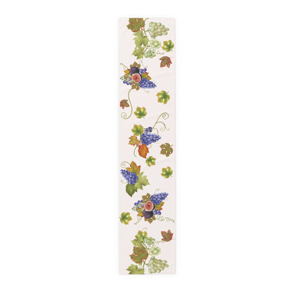 Fig & Grape fall table runner, purple grapes and turning vine leaves, on a wooden table