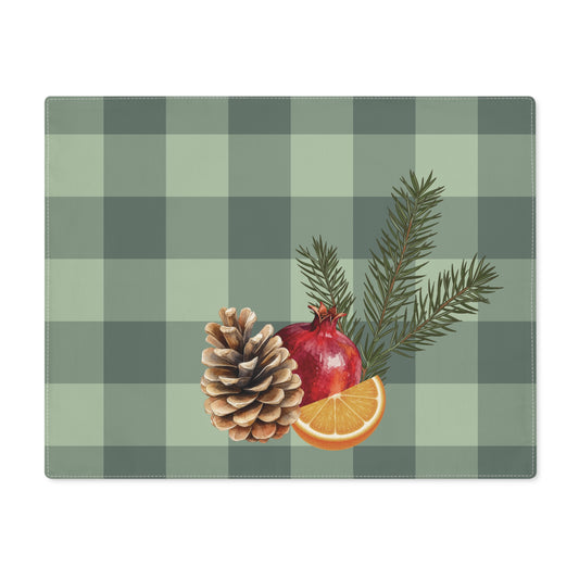 Pomegranate & Pine Gingham Christmas placemat, a pomegranate, pine cone, orange slice and gold star under a pine spray on a sage green gingham check