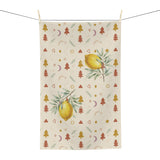 Lemon and pine Christmas tea towel shown flat, with watercolour lemons among small rust and gold Christmas trees, stars and crescent moons on cream