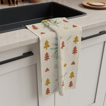 Lemon and pine Christmas kitchen towel folded over a counter edge