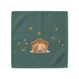 Nativity & Olive Christmas cloth napkin shown flat, a nativity stable with gold stars and olive sprigs on deep green
