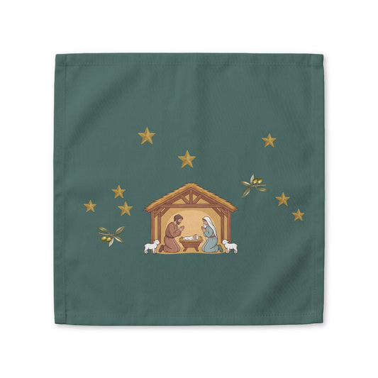 Nativity & Olive Christmas cloth napkin shown flat, a nativity stable with gold stars and olive sprigs on deep green