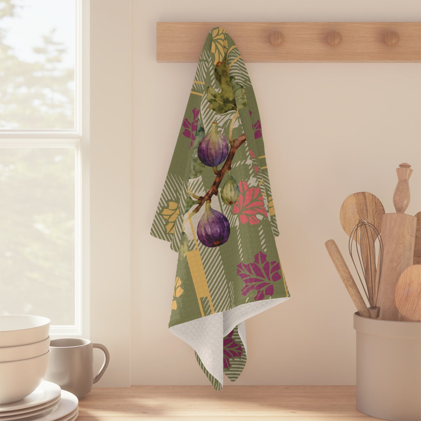 Fig & Maple fall tea towel, fig branch detail in the print, on a wooden worktop