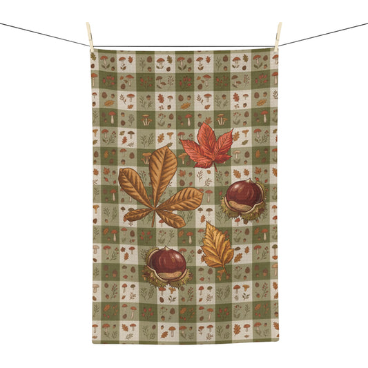 Chestnut & Mushroom fall tea towel, olive green gingham with chestnuts and mushrooms, hanging in a kitchen