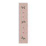 Blood orange check Christmas table runner laid flat, a red and cream checkerboard with holly and a cut blood orange
