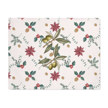 Poinsettia and olive Christmas placemat laid flat, with poinsettias, red holly berries, gold pine cones and olive branches on cream