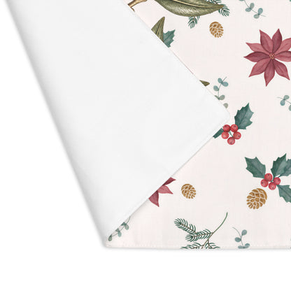 Corner of the Poinsettia and olive placemat folded back, showing the stitched hem and the plain white reverse