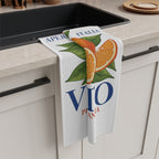 Spritz Veneto tea towel draped over the counter edge beside a dark kitchen sink