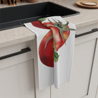 Tomato tea towel draped over the edge of a kitchen cabinet