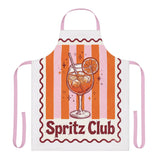 Spritz Club apron laid flat, showing the pink and orange stripes with the Spritz Club cocktail motif