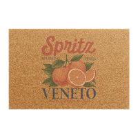 Spritz Veneto coir doormat seen from above on a plain background, showing the Spritz Veneto label print with oranges on natural coir