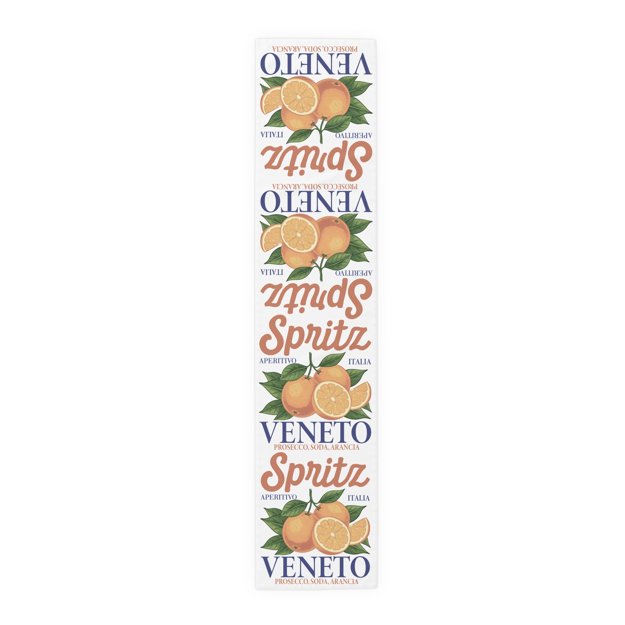 Spritz Veneto table runner, 16 by 72 inches in cotton twill, laid flat showing the repeating Spritz Veneto label print with oranges on a white ground
