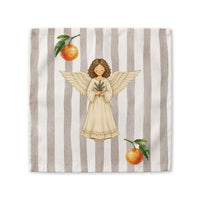 Angels and oranges Christmas cloth napkin laid flat, showing the angel and pine sprig on a soft grey stripe with oranges beside it