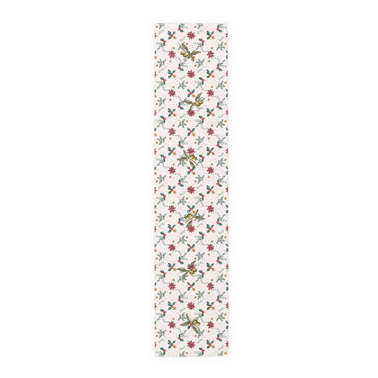 Poinsettia and olive Christmas table runner laid flat, showing poinsettias, red holly berries, gold pine cones and olive branches on cream