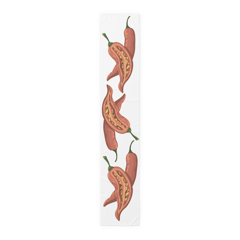 Chili Pepper table runner in cotton twill, 16 by 90 inches, the longer size laid flat with the same repeating print