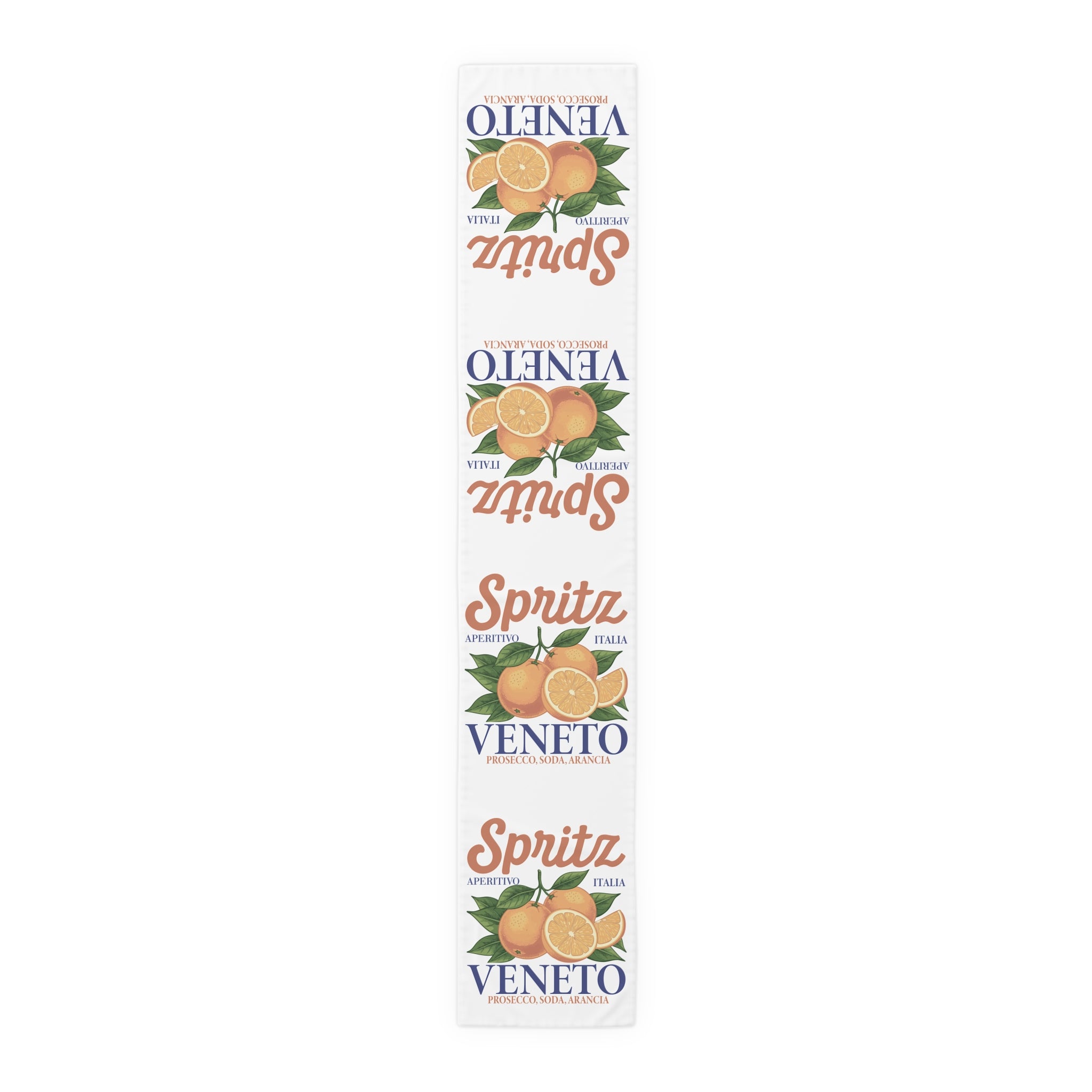 Spritz Veneto table runner, 16 by 90 inches in cotton twill, laid flat showing the repeating Spritz Veneto label print with oranges on a white ground