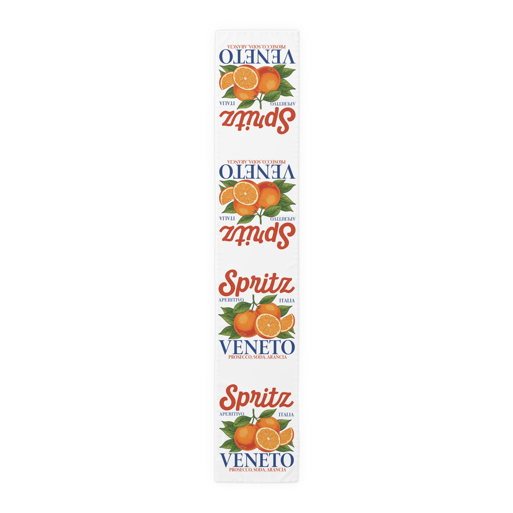 Spritz Veneto table runner, 16 by 90 inches in polyester, laid flat showing the repeating Spritz Veneto label print with oranges on a white ground