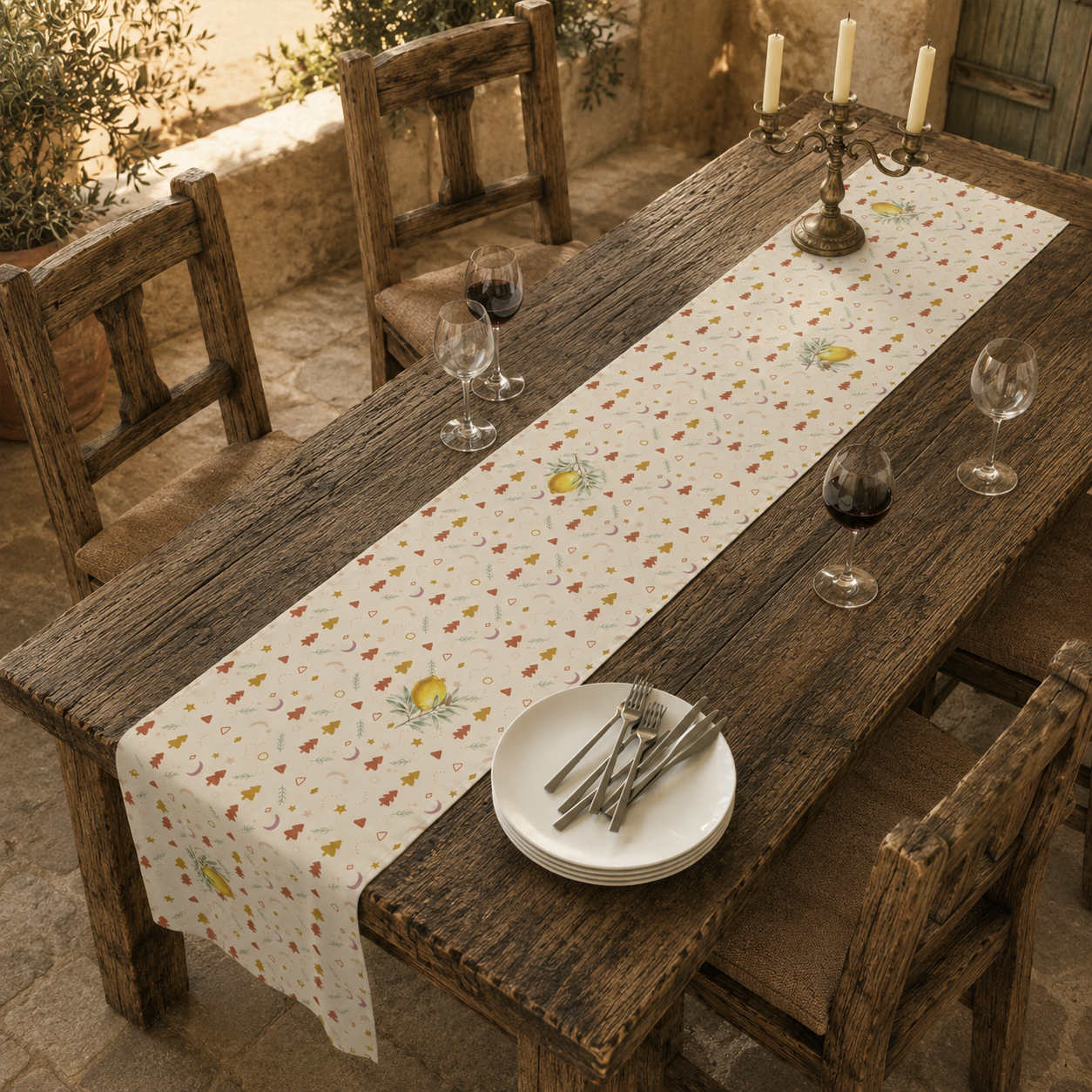 Lemon and pine Christmas table runner on a set table, the golden lemons and little Christmas trees in view