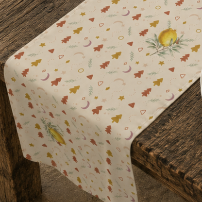 Close-up of the lemon and pine Christmas table runner, showing a watercolour lemon on its leafy branch between rust and gold trees
