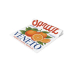 Spritz Veneto table runner rolled up, showing the printed surface and the hemmed edge