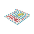 Limoncello Amore Mio table runner folded, showing the striped label print up close and the hemmed edge