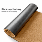 Coir doormat rolled back to show the black vinyl backing underneath, with the coconut-coir surface beside it