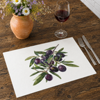 Olive Branch placemat on a wooden table with cutlery, a glass of red wine and a terracotta jug of daisies