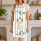 Woman wearing the Angels and holly Christmas apron in a light Mediterranean kitchen
