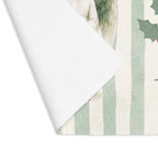 Corner of the Angels and holly placemat folded back, showing the stitched hem and the plain white reverse