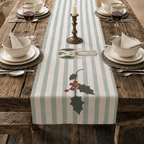Angels and holly table runner on a table set with cream bowls, woven placemats and glasses of red wine