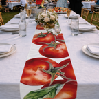 Tomato table runner down a long white banquet table set with glasses