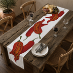 Chili Pepper table runner on a wooden table outdoors, with a plate and cutlery