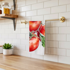 Tomato tea towel hanging from a brass rail against white subway tile