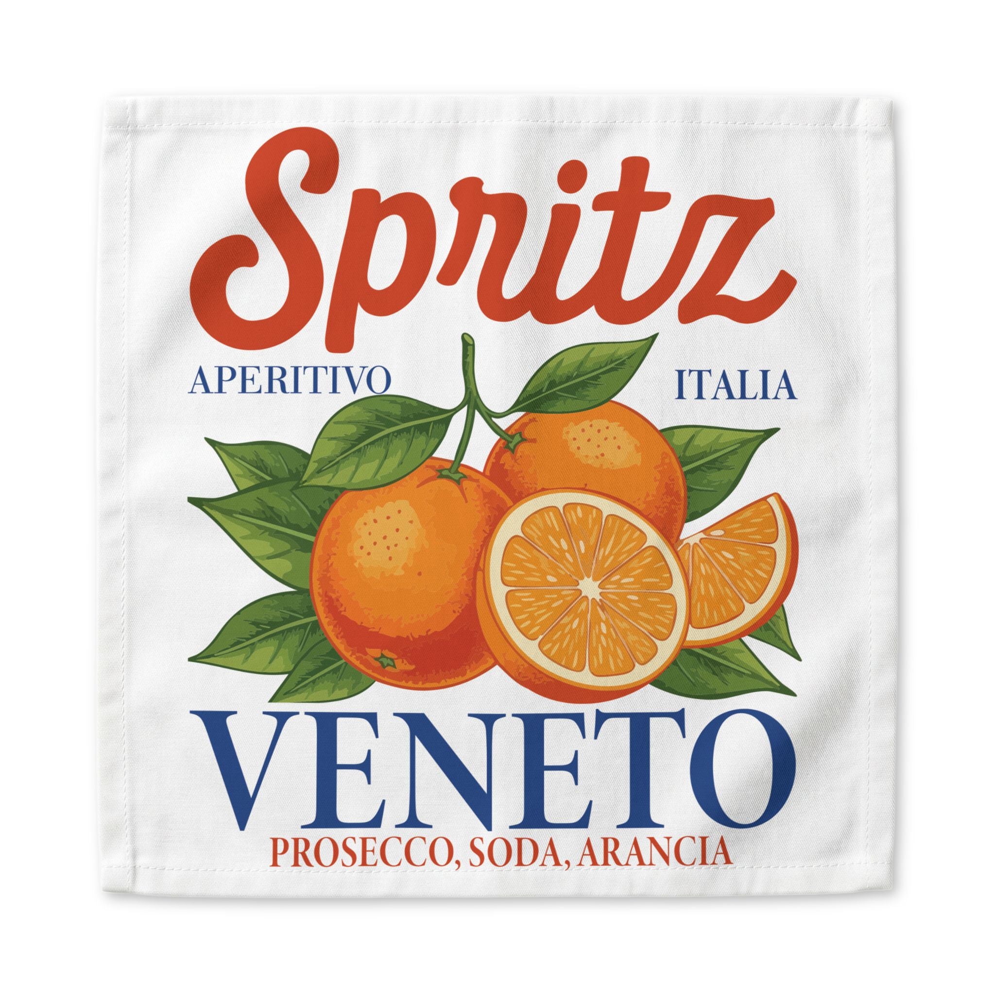 Spritz Veneto cloth napkin, 22 by 22 inches, laid flat showing the Spritz Veneto label print with oranges on a white ground
