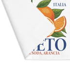 Corner of the Spritz Veneto placemat folded back, showing the stitched hem and the woven fabric surface